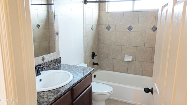 full bathroom featuring toilet, tiled shower / bath, and vanity