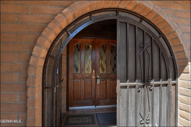 property entrance featuring brick siding