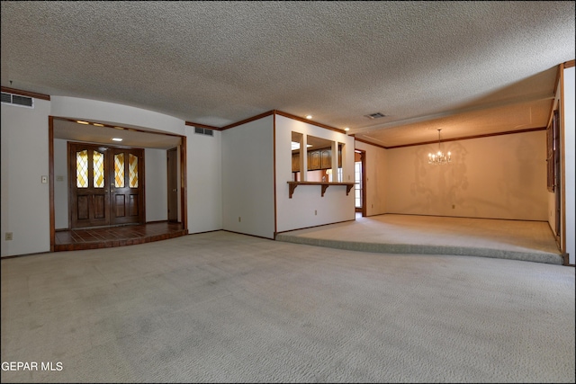 unfurnished living room with carpet floors, a chandelier, visible vents, and ornamental molding