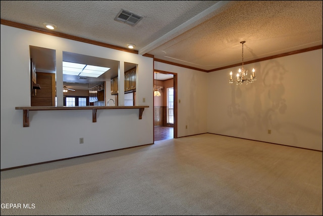 spare room with a wealth of natural light, carpet flooring, and visible vents