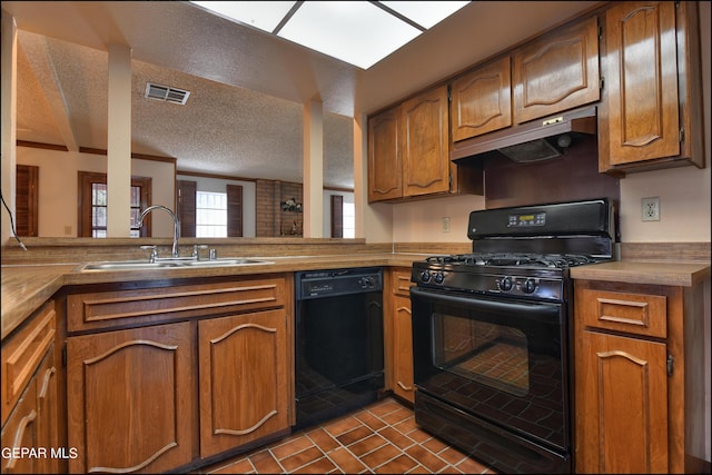 kitchen with visible vents, brown cabinetry, under cabinet range hood, black appliances, and a sink