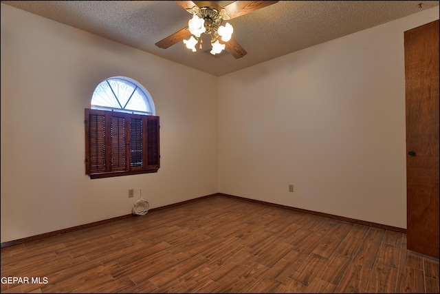 empty room featuring a ceiling fan, a textured ceiling, baseboards, and wood finished floors