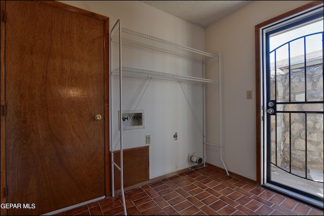 washroom with hookup for a washing machine, electric dryer hookup, a textured ceiling, laundry area, and baseboards