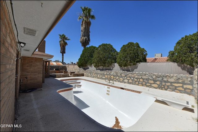 view of patio featuring fence