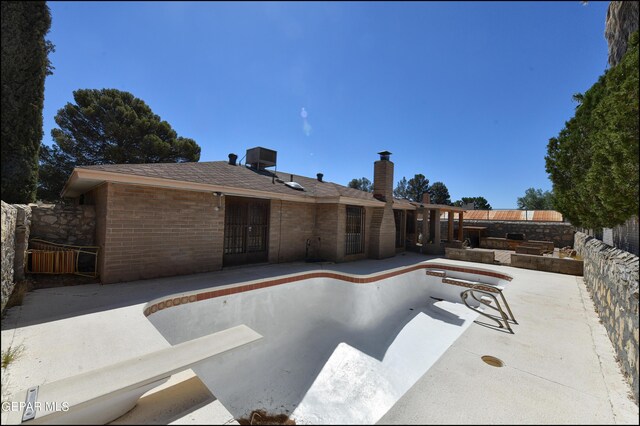 view of pool with a patio area and fence