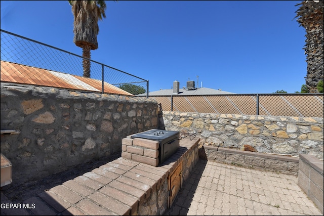 view of patio featuring cooling unit and fence