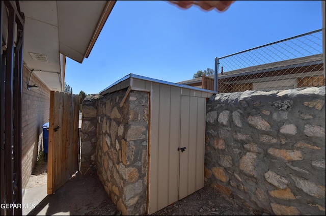 view of shed with fence