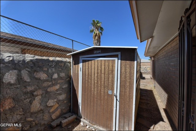 view of shed featuring fence