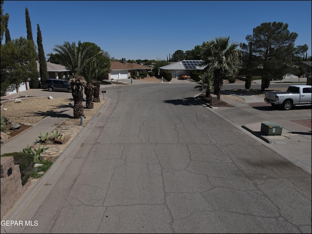 view of road featuring a residential view and curbs