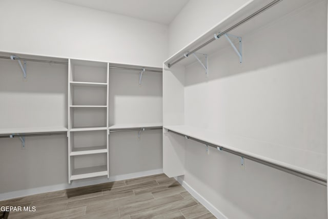 walk in closet featuring wood tiled floor