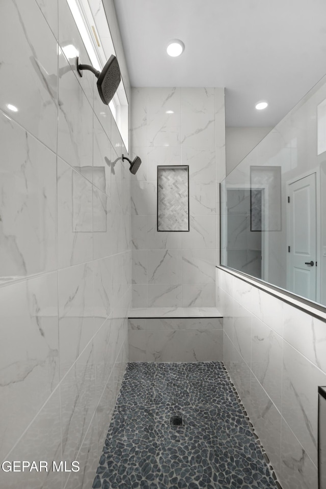 full bathroom with tiled shower and recessed lighting