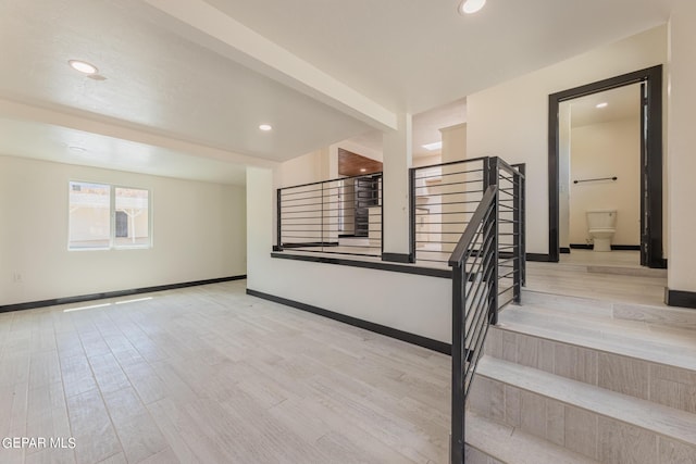 staircase featuring beamed ceiling, recessed lighting, baseboards, and wood finished floors