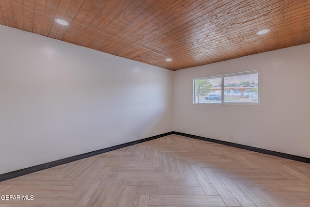 empty room with wood ceiling, recessed lighting, and baseboards