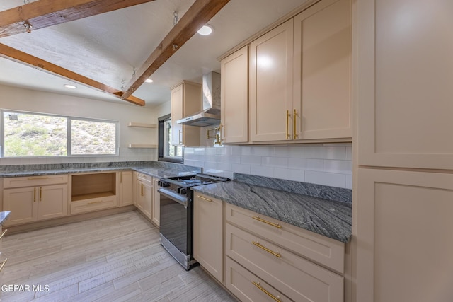 kitchen with tasteful backsplash, wall chimney range hood, stainless steel range with gas stovetop, beam ceiling, and open shelves