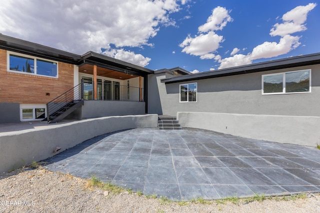 back of property featuring stucco siding and a patio