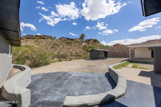 view of patio featuring an outbuilding