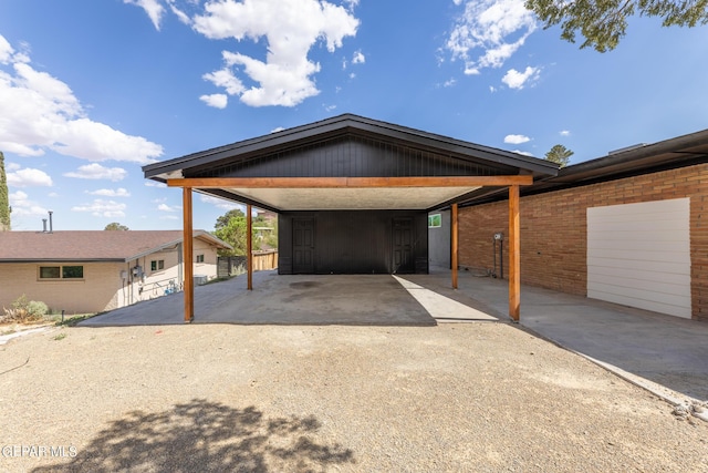 view of front of home featuring a carport, brick siding, and driveway