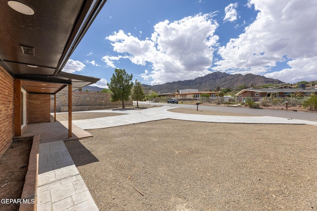 view of yard with fence and a mountain view