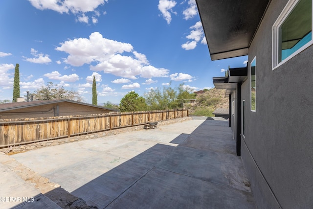 view of patio / terrace featuring fence