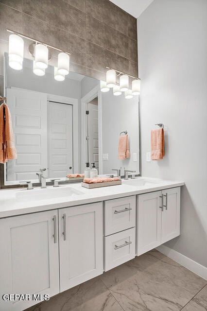 bathroom featuring tile patterned flooring and double sink vanity