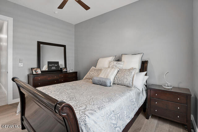 bedroom with ceiling fan and light hardwood / wood-style floors