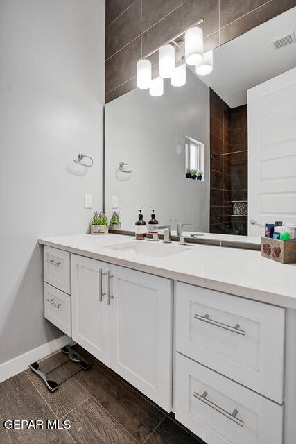 bathroom with hardwood / wood-style floors and vanity