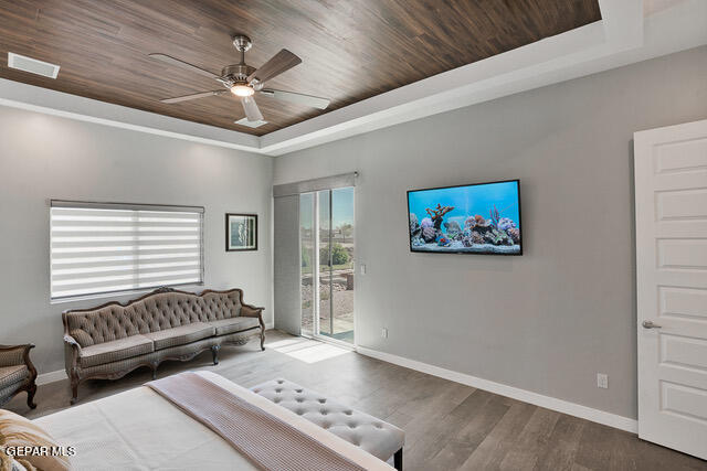 living room featuring wood ceiling, ceiling fan, a raised ceiling, and hardwood / wood-style flooring