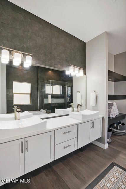 bathroom with hardwood / wood-style floors and dual bowl vanity