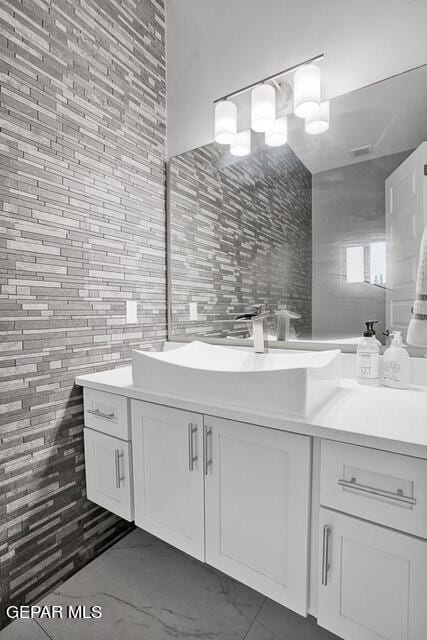 bathroom with tile patterned floors, vanity, and tile walls