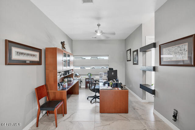 tiled office space featuring ceiling fan