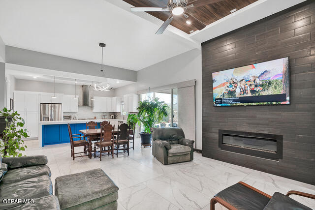 tiled living room featuring wooden ceiling, ceiling fan, and tile walls