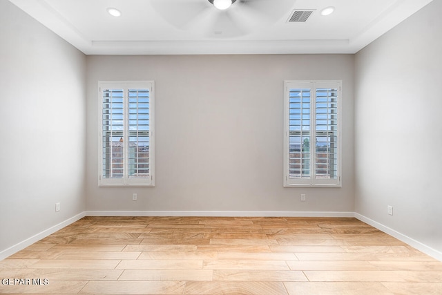 unfurnished room featuring a wealth of natural light, light wood-type flooring, and ceiling fan