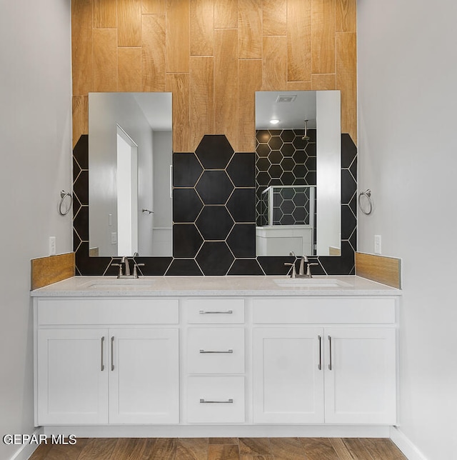 kitchen with sink, light wood-type flooring, and white cabinetry