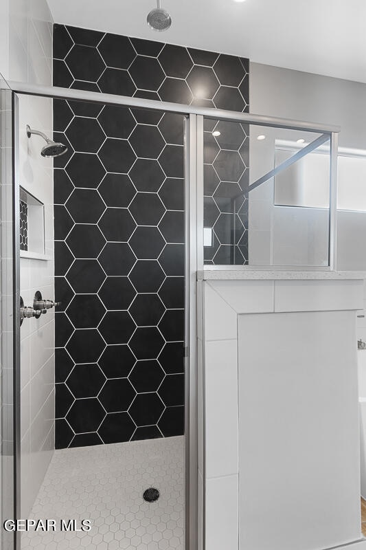 bathroom with a shower with shower door