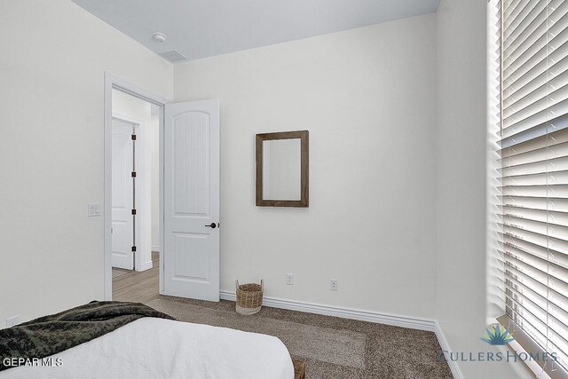 bedroom with light colored carpet