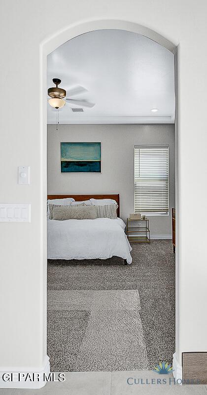 unfurnished bedroom featuring ceiling fan and carpet floors