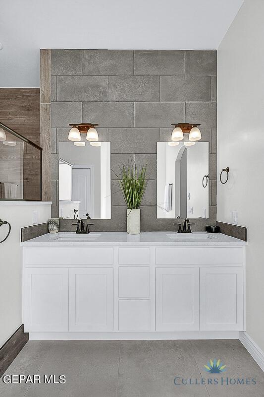 bathroom featuring tile patterned flooring and dual bowl vanity