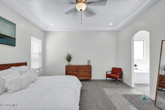 bedroom with ceiling fan, connected bathroom, and carpet floors