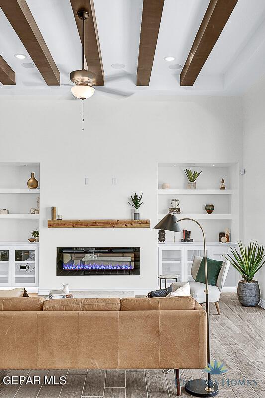 living room with hardwood / wood-style flooring and built in shelves