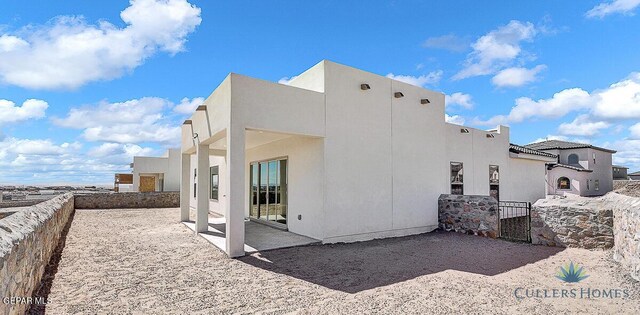 rear view of property featuring a patio area