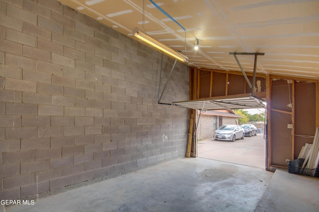 garage with concrete block wall