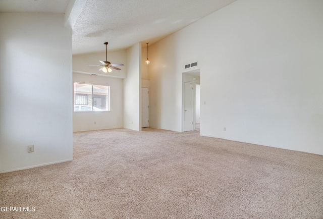 spare room featuring visible vents, high vaulted ceiling, a textured ceiling, carpet, and ceiling fan