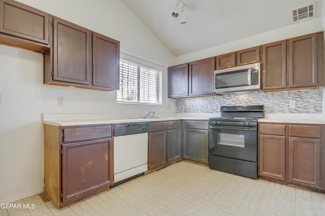 kitchen featuring light floors, visible vents, black gas range, dishwasher, and stainless steel microwave