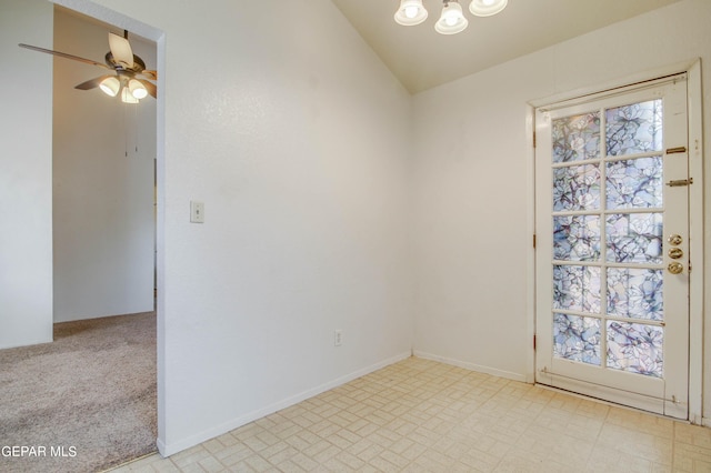 spare room featuring baseboards, ceiling fan with notable chandelier, a healthy amount of sunlight, and vaulted ceiling