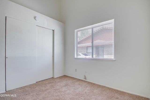 unfurnished bedroom with a closet and carpet