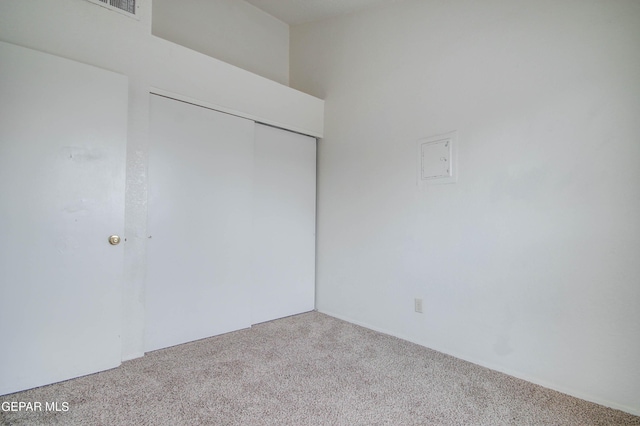 unfurnished bedroom with a closet and carpet floors