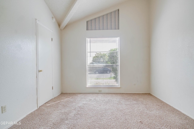 unfurnished room featuring lofted ceiling and carpet floors