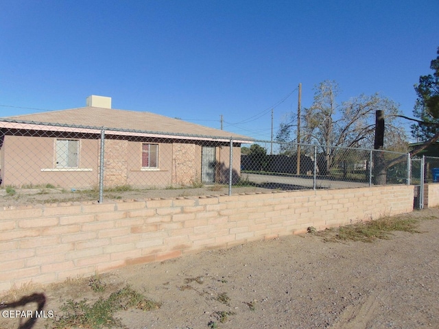 view of side of home featuring fence