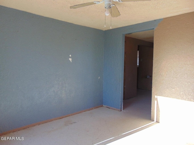 spare room with ceiling fan and a textured ceiling