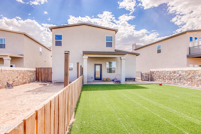 rear view of house with a patio and a yard